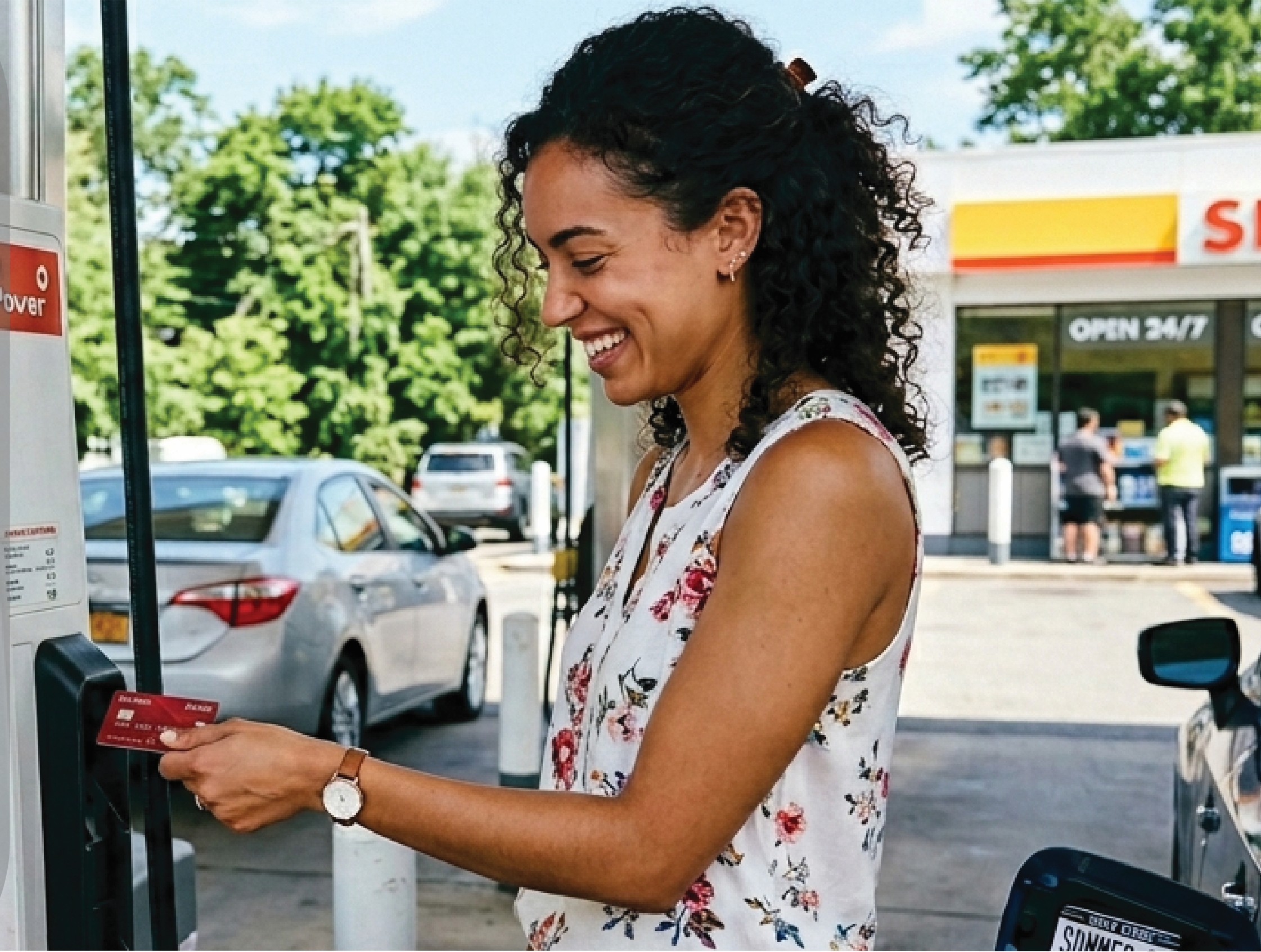 Lady inserting her card at the gas pump